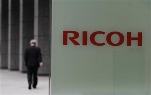 A man walks in front of the headquarters of Ricoh Co in Tokyo May 26, 2011.  REUTERS/Toru Hanai